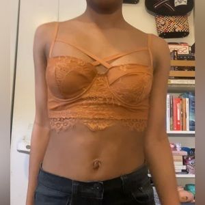 Camel orange lacy bralette style top with zipper closure.